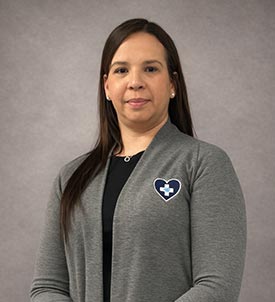 Shaynie posing for a picture on grey background