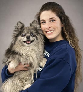 Sydney posing for a picture with a dog on grey background