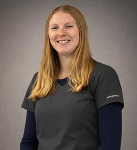 Samantha posing for a picture on grey backgroun