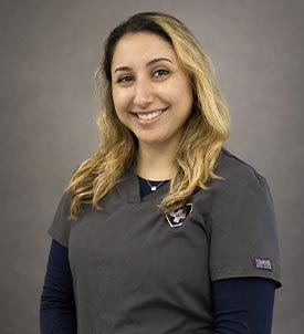 Emily posing for a picture on grey background