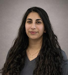 Shaiza posing for a picture on grey background