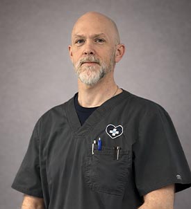 Mark H. posing for a picture on grey background